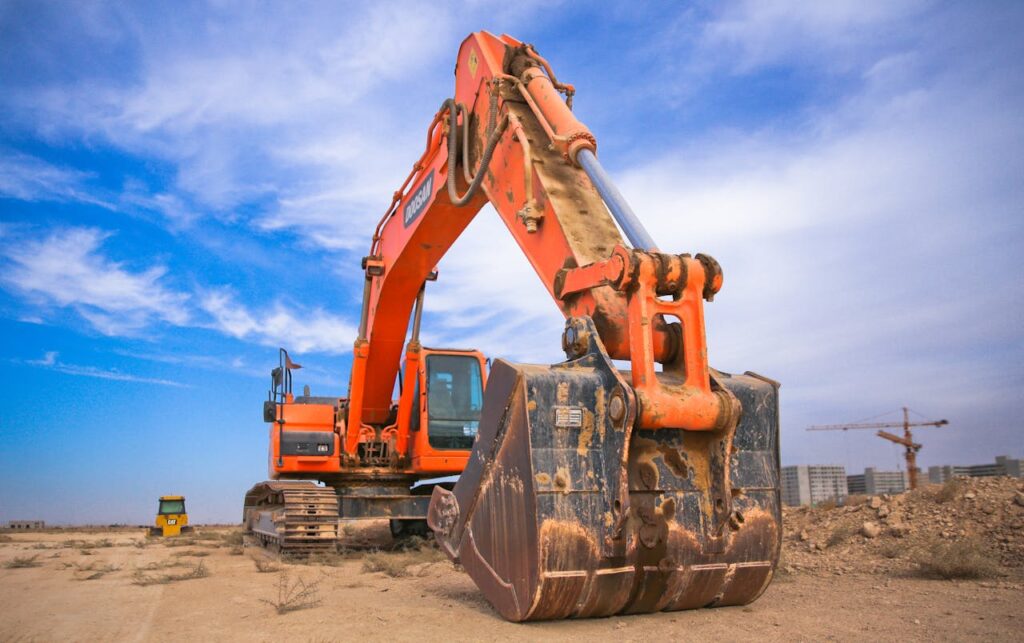 zipwp-image-1078884 Low Angle Photography of Orange Excavator Under White Clouds